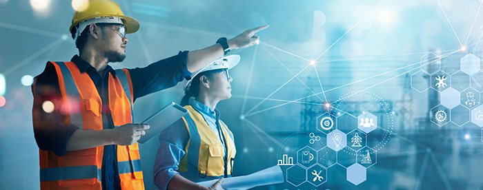 Construction workers analyzing digital plans